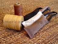Dog bite tug made of leather with handle.